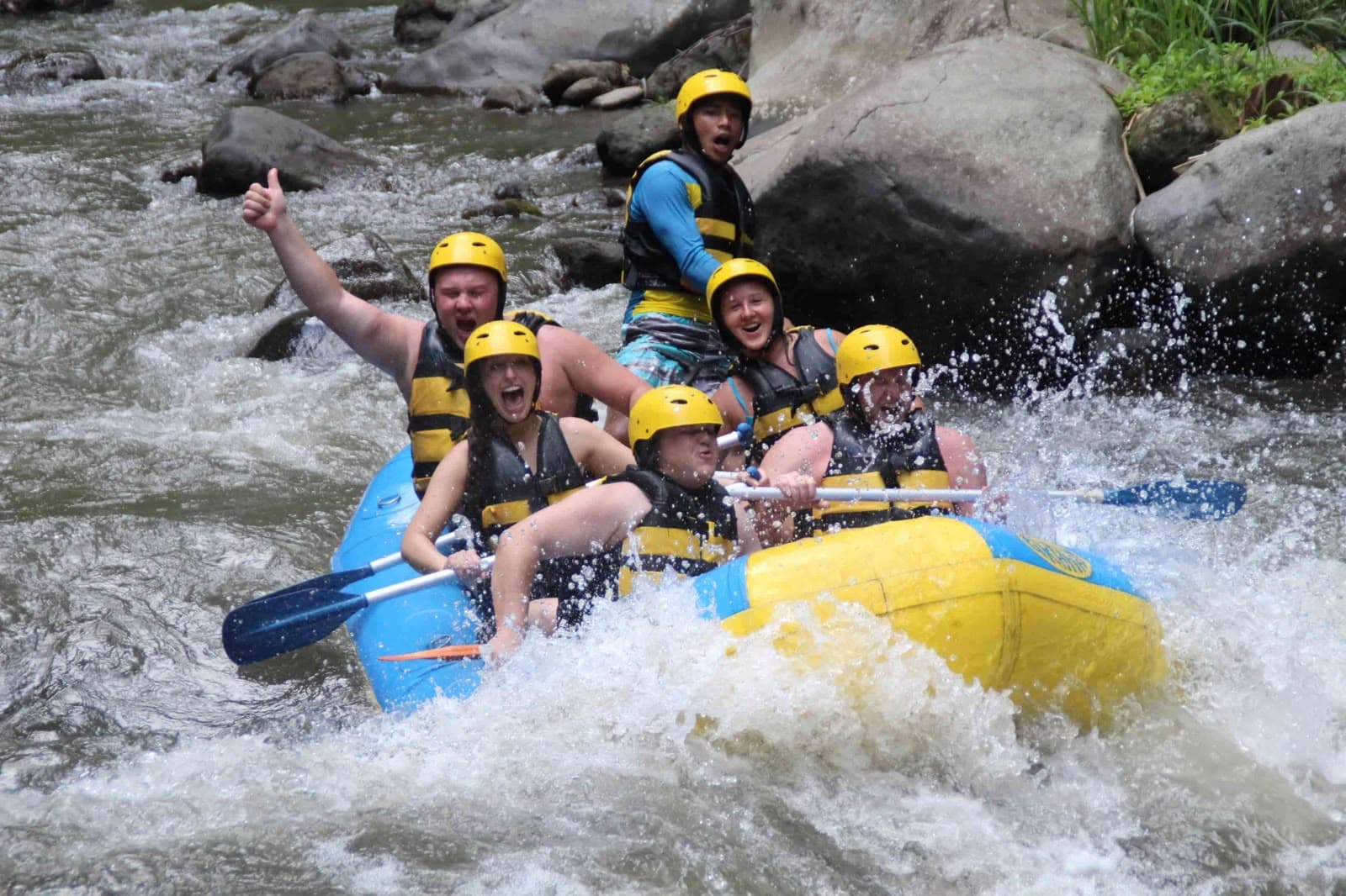 White water rafting down Ayung River through lush jungle gorge Ubud Bali